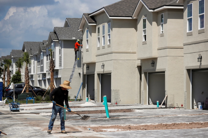 A carpenter works on building new townhomes that are still under construction while building material supplies are in high demand in Tampa, Florida, U.S., May 5, 2021. REUTERS/Octavio Jones